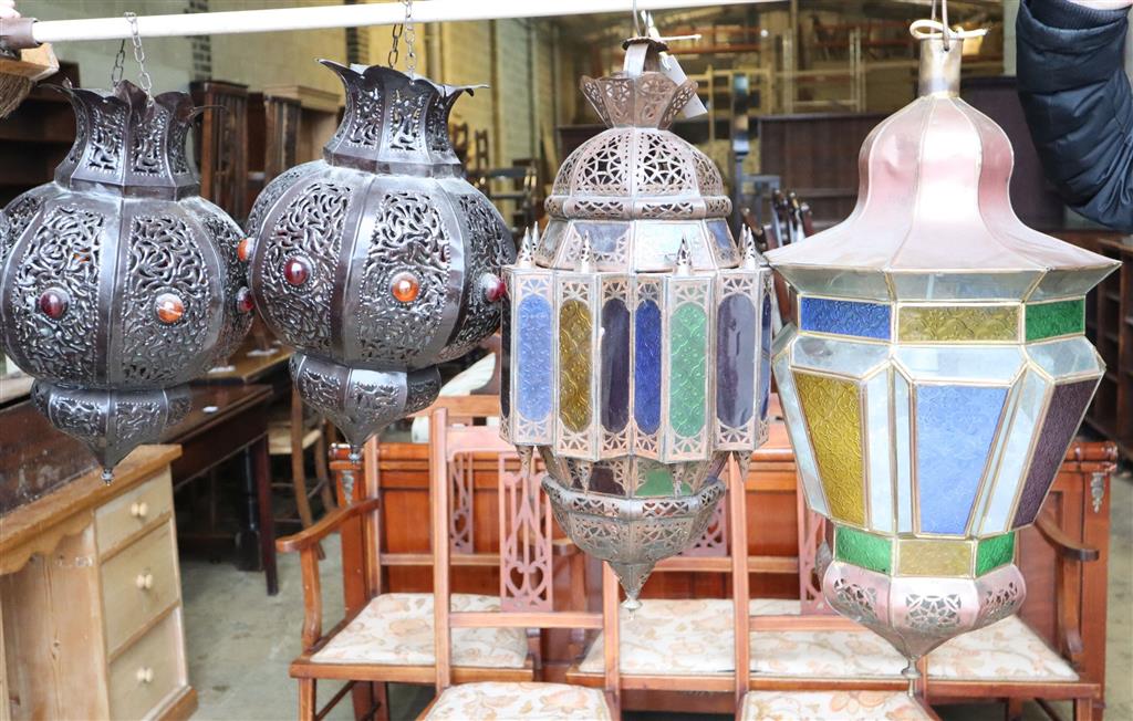 Two Moroccan copper and stained glass octagonal hanging lanterns and a pair of pierced bronzed metal lanterns, largest 66cm high